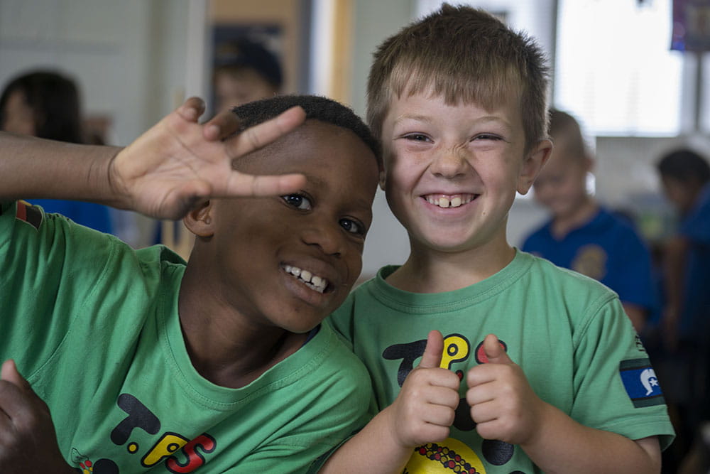 Two children smiling at the camera