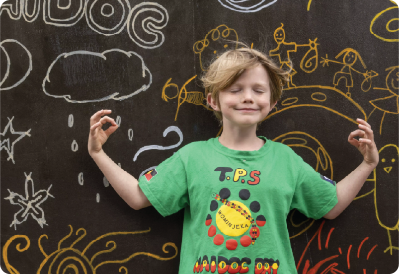 Boy standing in front of chalk board