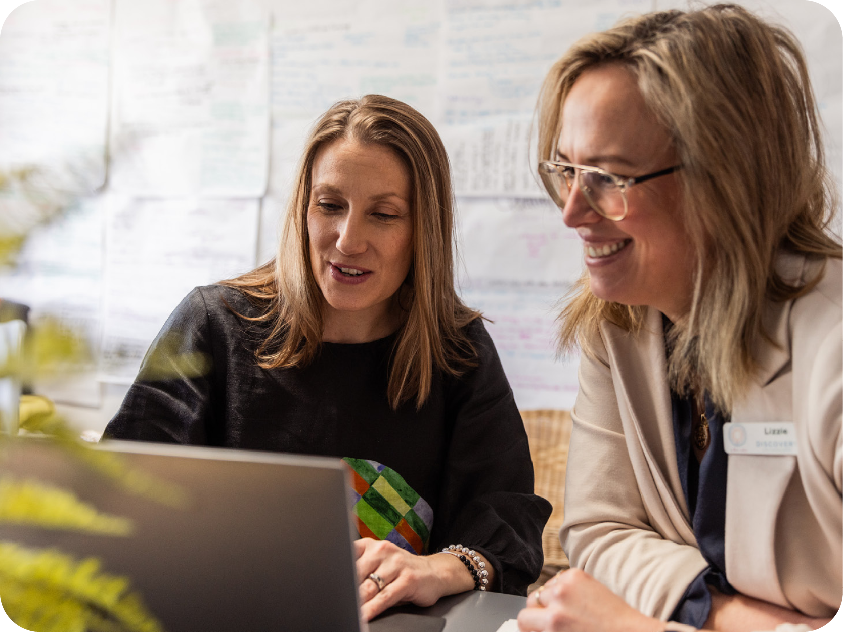 Two educators looking at a laptop