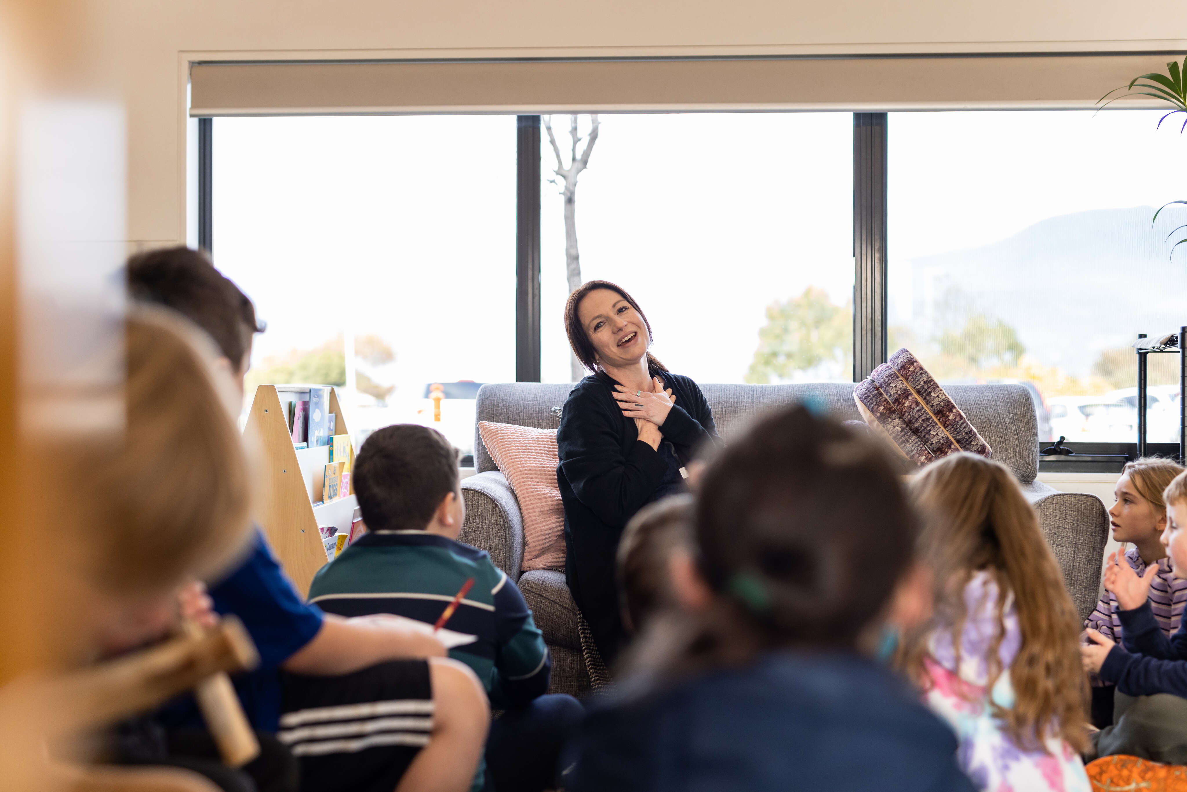 An educator laughs with children