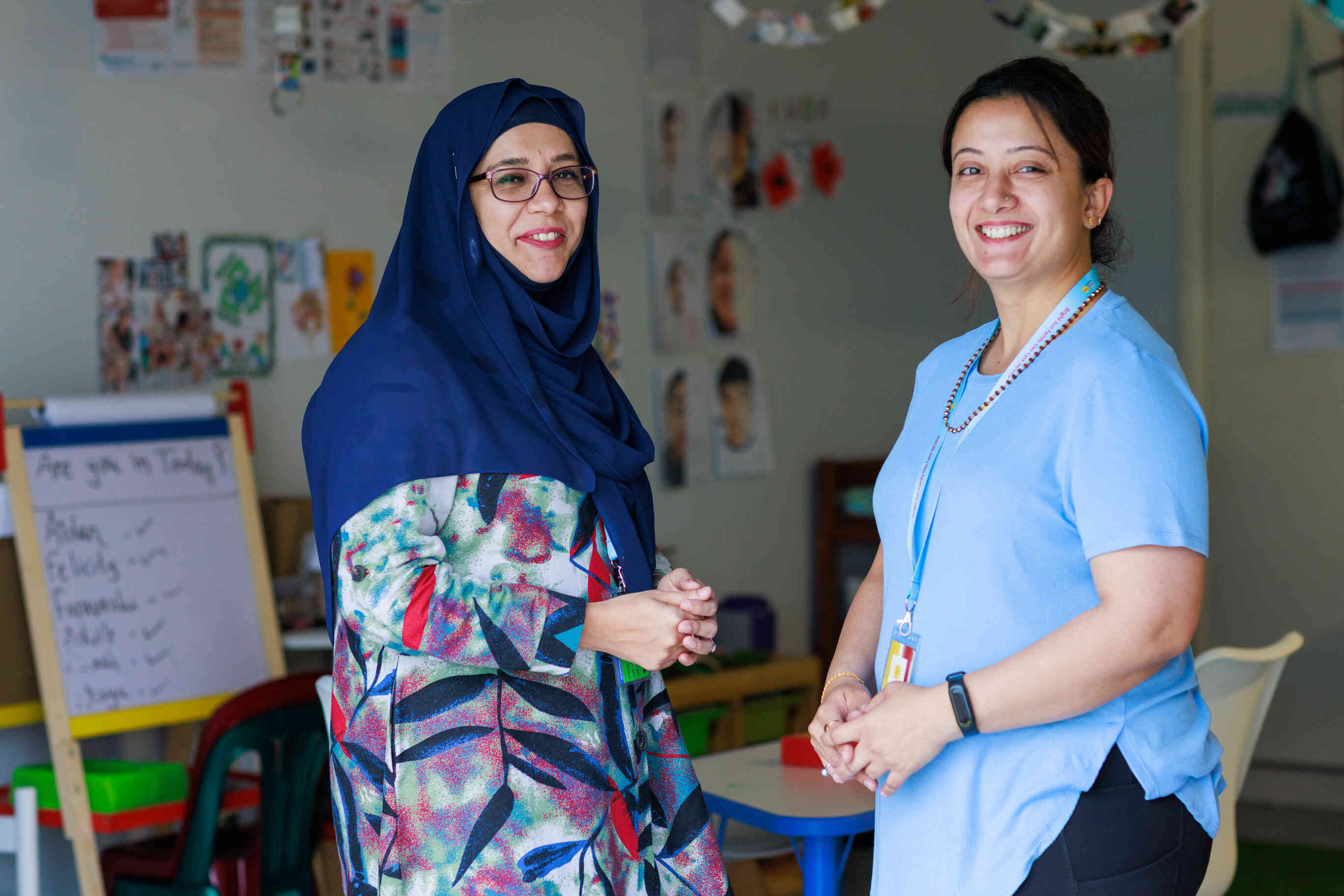 Two educators smiling looking to camera