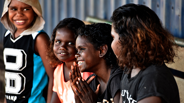 Four smiling children in the schoolyard